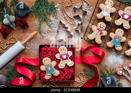 Top down view of baking gingerbread men cookies and packing them in a gift box for a present Stock Photo