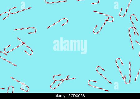 Random candy canes on light blue background Stock Photo