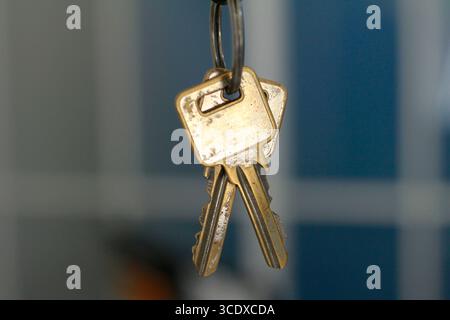 The key hangs on a black background. Stock Photo