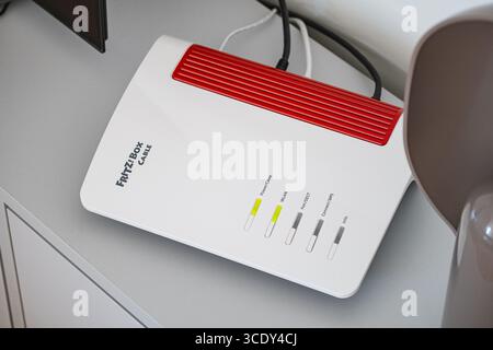 Close-up of a white and red FRITZ!Box cable internet router Stock Photo