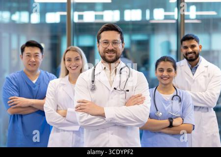 A team of diverse healthcare professionals confidently smiling in a modern hospital setting. Showcasing teamwork and dedication in providing quality medical care and fostering trust with patients. Stock Photo