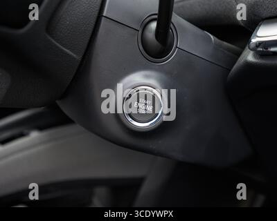Derby, UK - August 14, 2025: close-up of a modern cars engine start/stop button, highlighting its sleek design and keyless ignition functionality with Stock Photo