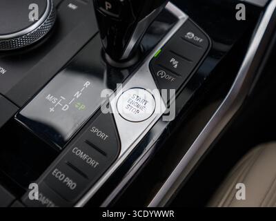 Derby, UK - August 14, 2025: close-up of a modern cars engine start/stop button, highlighting its sleek design and keyless ignition functionality with Stock Photo
