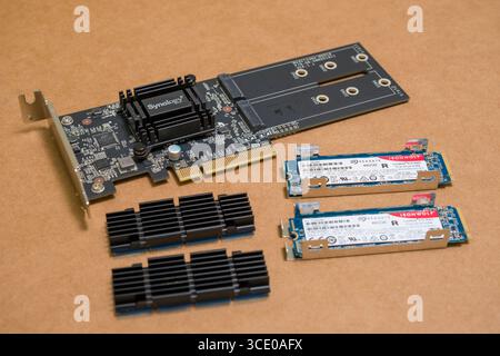 Synology M2D18 PCI Express x8 Adapter Card for Dual M.2 SSDs with Seagate IronWolf 510 SSD, M.2 PCIe Gen3 x4 NVMe SSD and heatsinks before assembly Stock Photo
