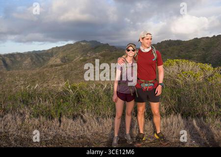 Man and woman hikers posing for a photograph on Kamehame Ridge in the Koolau Rage, Hawaii Kai, Honolulu, Oahu, Hawaii, USA Stock Photo