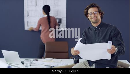 Blueprints, collaboration and construction with architect people in office for property development. Building, documents and floor plan with Stock Photo