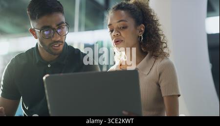 Laptop, discussion and web developers in office with troubleshooting online problem. Computer, team and IT professionals with conversation on Stock Photo