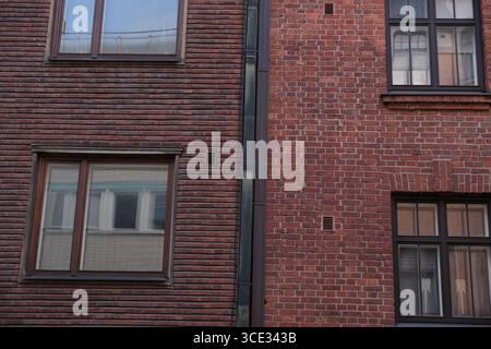 Building façade with red brick and decorative design representing architecture in Helsinki Stock Photo