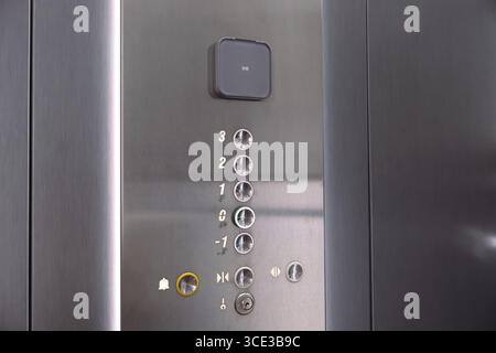 Close-Up of Metal Elevator Buttons with Floor Indicators. Detailed view of a stainless steel elevator control panel displaying buttons and floor Stock Photo