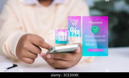 Person using smartphone with holographic online payment form, shopping cart, and discount icons, representing e-commerce, mobile shopping, and secure Stock Photo