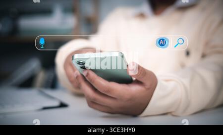 Person holding smartphone with search bar featuring microphone and AI icons, representing AI-powered search, voice search, and smart mobile technology Stock Photo
