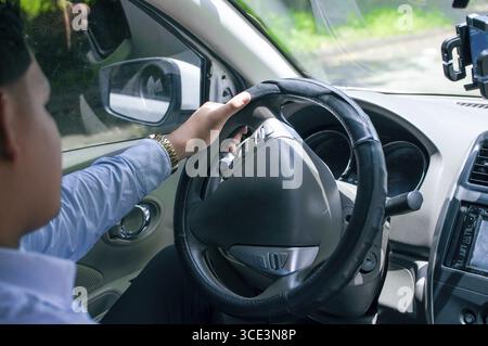 Close-up of man driving casual his car Stock Photo