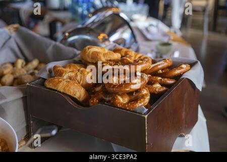 Box of pretzels and croissants on a laid table, brewhouse Schoenbuch, Boeblingen, Germany Stock Photo
