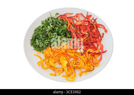 Dried sweet peppers and parsley on a ceramic plate isolated on a white background. Various dry of vegetables. Ingredient for preparing a freeze-dried Stock Photo