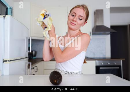 Exhausted young woman taking a break from meal preparation at home Stock Photo