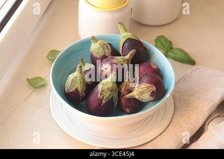 Mini eggplants in bowl. Vegetables and healthy eating. Ecologically clean products from the garden. Stock Photo
