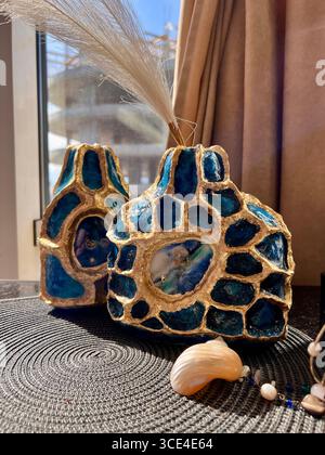 A voluminous blue vase with gold accents, made of papier-mâché, Art Deco style Stock Photo