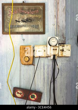Vintage electric control panel with retro signs and wires on a weathered wall background showcasing rustic charm cafe malaysia Stock Photo