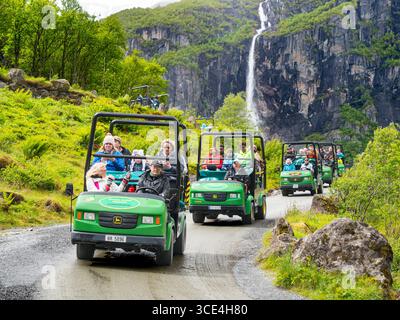 Troll cars by a waterfall on the road to the Briksdal Glacier Olden Norway Stock Photo