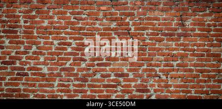 An old shabby red brick wall background. Close up. Stock Photo