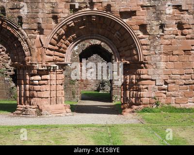 A detailed close-up of the highly decorative, carved sandstone arches and Gothic architecture at Furness Abbey Stock Photo