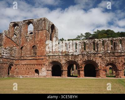 A detailed close-up of the highly decorative, carved sandstone arches and Gothic architecture at Furness Abbey Stock Photo