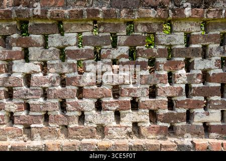 Lattice brick wall at Middleton Place Plantation, built with reclaimed bricks from the mansion ruins burned in 1865 during the Civil War. Stock Photo