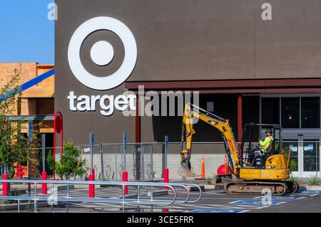 Queen Creek, Arizona, USA. 15th Aug, 2025. A construction worker operates a compact excavator outside the Target store under construction at the Vineyard Towne Center shopping development on the Maricopa-Pinal county line. Commercial, residential, and data center construction continues across the Phoenix metro area as the real estate market cools after years of rapid gains, with more listings easing pressure on buyers. (Credit Image: © Eduardo Barraza/ZUMA Press Wire) EDITORIAL USAGE ONLY! Not for Commercial USAGE! Stock Photo