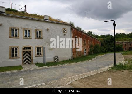 Contrasting facades of restored and decaying buildings at Owcza Góra Fortress in Kłodzko, Poland Stock Photo