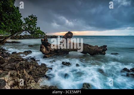 Waves splashing on a rocky coastline, Tanjung Lesung beach, Pandeglang Regency, Banten, Java, Indonesia Stock Photo