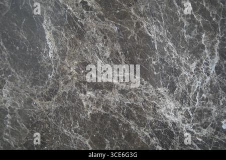 Dark marble surface with intricate white veining patterns Stock Photo