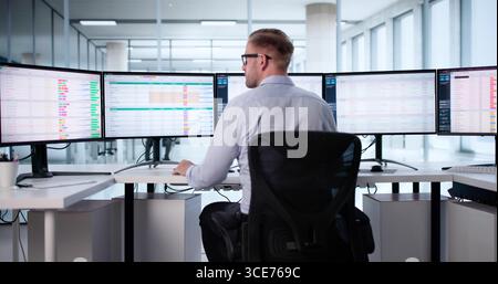 Medical Data Coding: Man Analyzing Patient Billing With Spreadsheet Software. Stock Photo