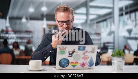 Male Graphic Designer Texting On Smartphone In Hipster Cafe Shop. Stock Photo