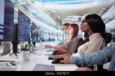 Corporate Analyst Leads Diverse Team Analyzing KPIs In College Classroom. Stock Photo