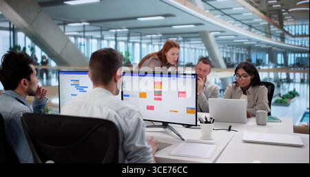 Multiracial Team Using Kanban Board For Agile Software Development Stock Photo