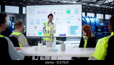 Diverse Group Of Professionals Giving Training Session On New AI System. Stock Photo