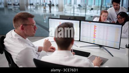 Hospital Doctors Analyzing Billing Codes Online, Diverse Medical Team Collaborating. Stock Photo