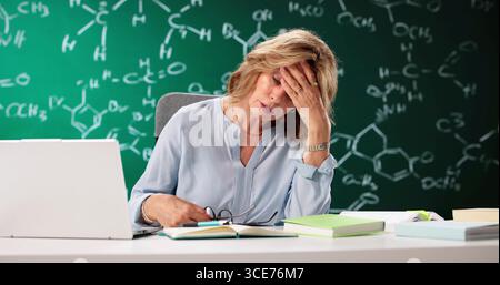 Overworked Senior Professor Struggles With Balance And Pressure In Classroom. Stock Photo
