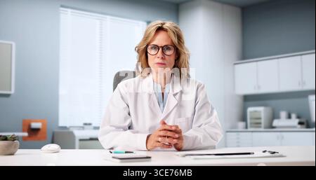 Female Doctor Leading Online Medical Training For Healthcare Professionals Stock Photo