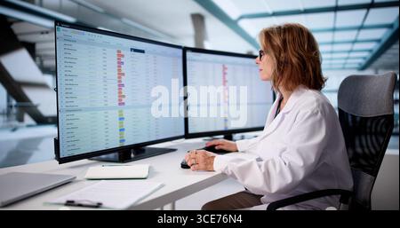 Senior Nurse Using Clinical Coding On Computer For Medical Billing Stock Photo