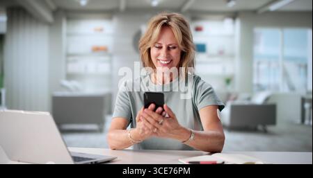 Senior Woman Using Digital Continuous Glucose Monitor On Mobile Phone. Stock Photo