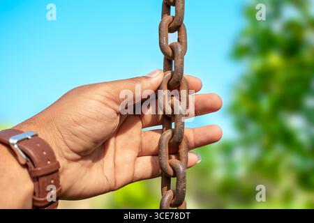 Old rusty metal chain hanging, Rusty chain links outdoors in close up, Stock Photo