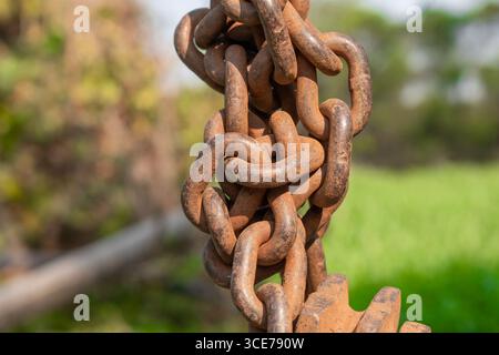 Old rusty metal chain hanging, Rusty chain links outdoors in close up, Stock Photo
