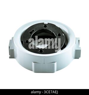 Ceiling light fixture housing in round plastic design with black inner ring, used for recessed installation, isolated on white background. Stock Photo