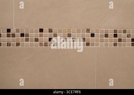 Tiles in the bathroom with patterns, cozy and beautiful. Neutral-toned tiled wall emphasizing minimal design and featuring a modern beige Stock Photo