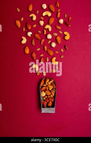 Premium mixed nuts including pistachios, almonds, cashews, walnuts, hazelnuts, pecans, and macadamia, gourmet healthy snack photography. Stock Photo