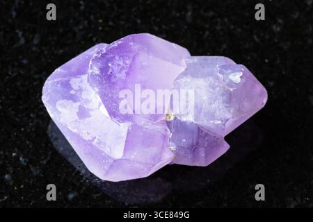 sample of raw amethyst crystals on black granite background close up from Madagascar Stock Photo