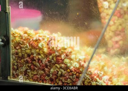A close up of colorful popcorn in a glass popcorn machine. Stock Photo