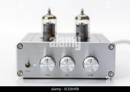 A silver tube amplifier front view brushed metal finish three control knobs for treble bass volume two vacuum tubes minimalist design high fidelity Stock Photo
