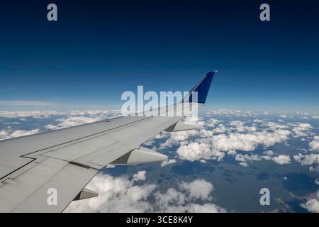 Clear blue skies with puffs of white clouds as seen from a Delta Airlines domestic flight, 2025, United States Stock Photo
